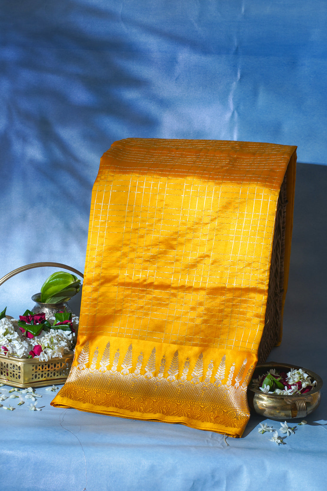 Yellow saree with a textured pattern on a blue background